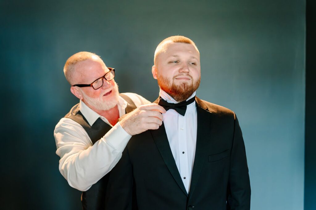 Groom getting dressed at Bella Cosa Wedding Venue