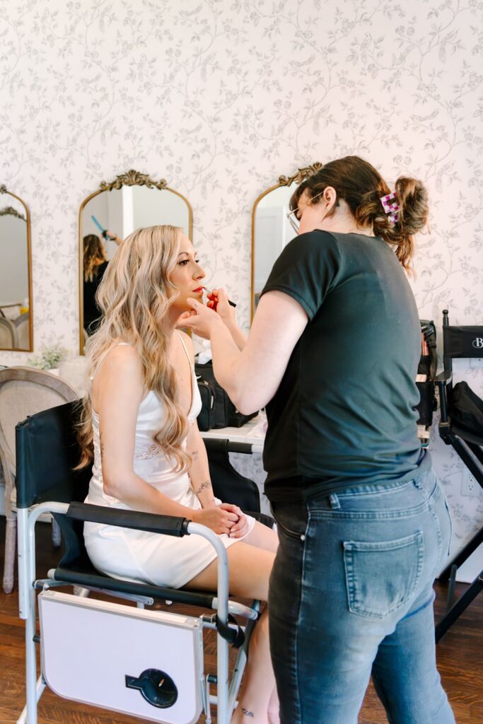 Bride getting her makeup done at Bella Cosa Wedding Venue