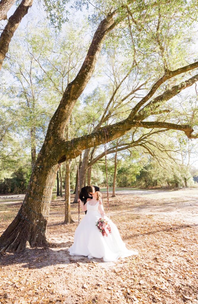 Bride and groom on swing set at the Granville Plantation 