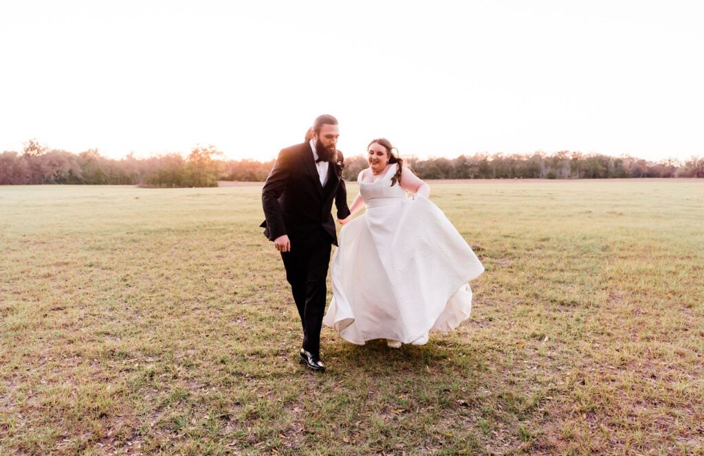 Bride and Groom dancing in a field at the Granville Plantation wedding