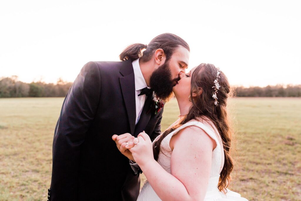 Bride and Groom pinky swear in a field at their Granville Plantation wedding