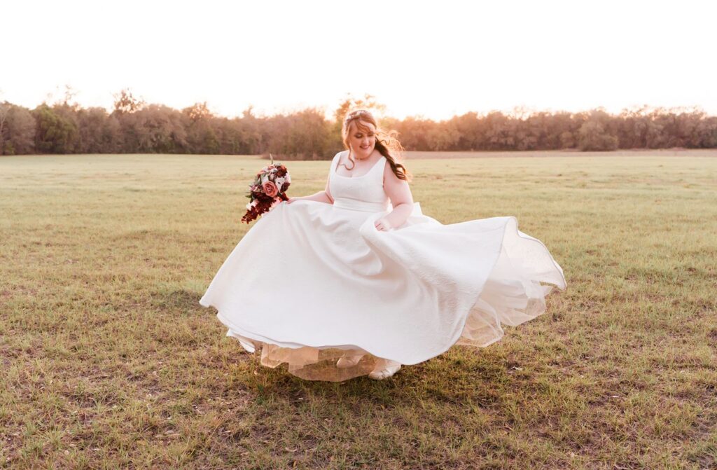 Bride dancing in a field at her Granville Plantation wedding
