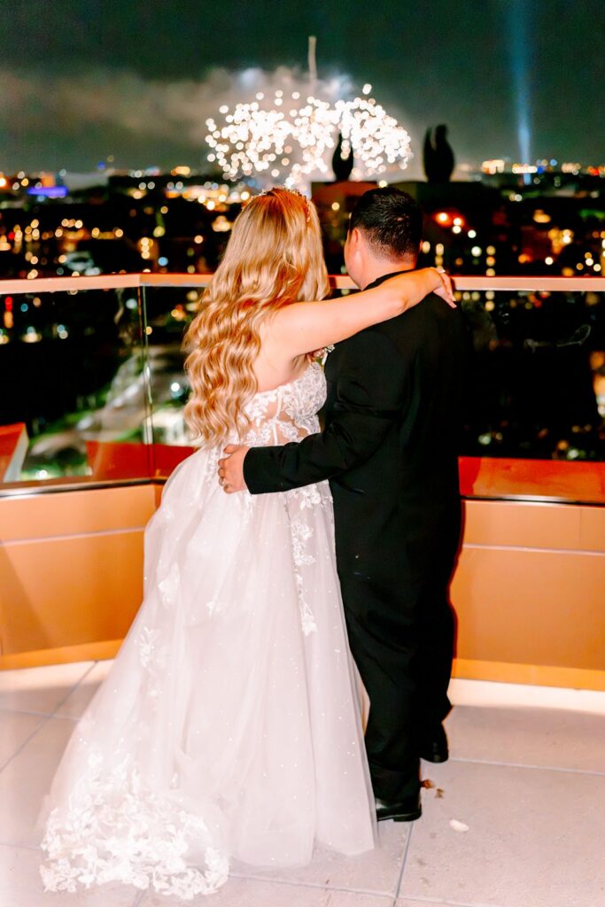 Bride and Groom celebrating with EPCOT fireworks at the Swan Reserve